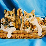 Free standing painting of a basket of kittens, painted on wood.